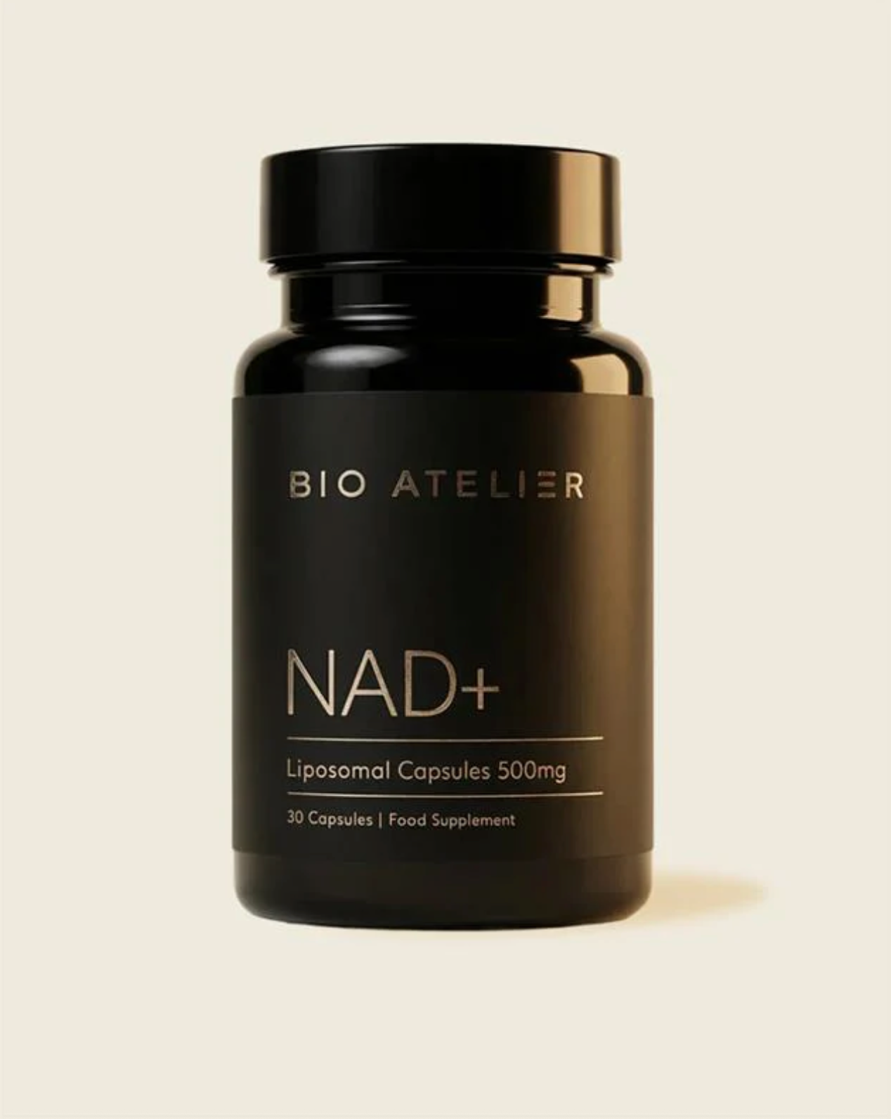 Black supplement bottle labeled 'BIO ATELIER NAD+' on a beige background