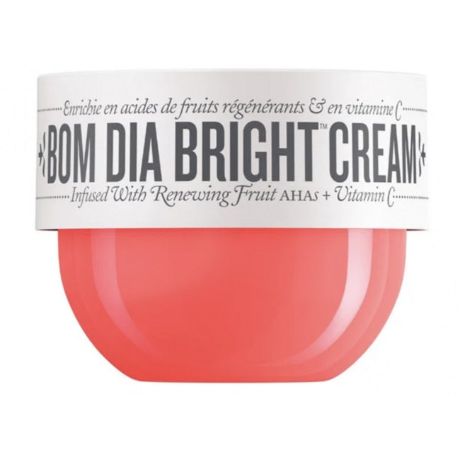 A jar of BOM DIA BRIGHT CREAM with a white label and a translucent coral-pink container, shown on a plain white background.