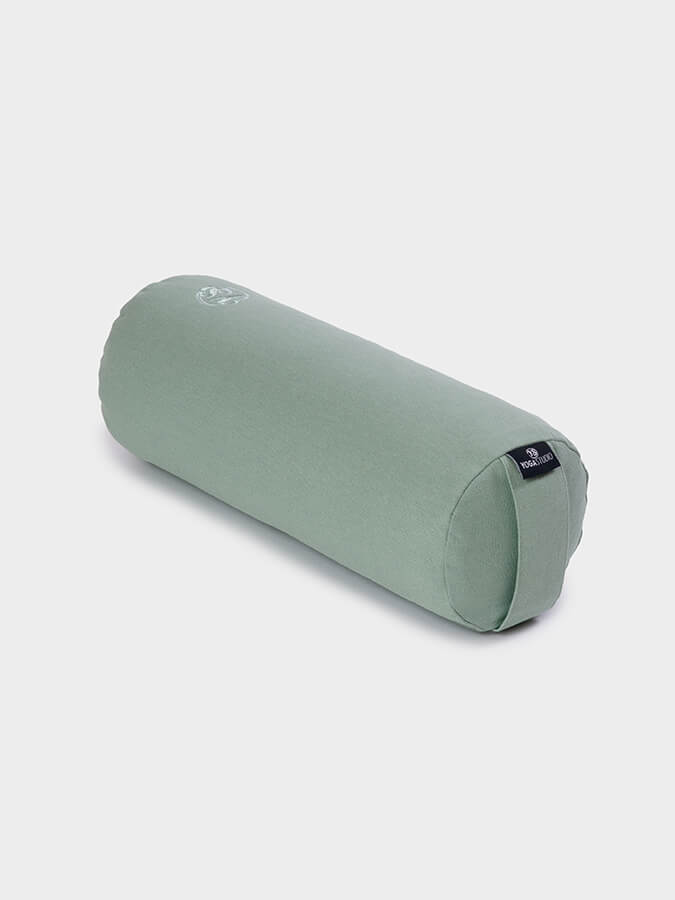 Green cylindrical pillow on a light gray background