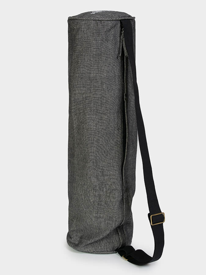 Gray yoga mat with a black strap on a white background