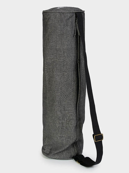 Gray yoga mat with a black strap on a white background