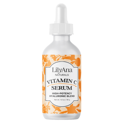 A white dropper bottle of LilyAna Naturals Vitamin C Serum with an orange and white patterned label, isolated on a white background.