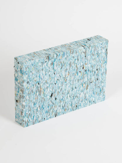Rectangular block with a speckled blue and gray pattern on a white background