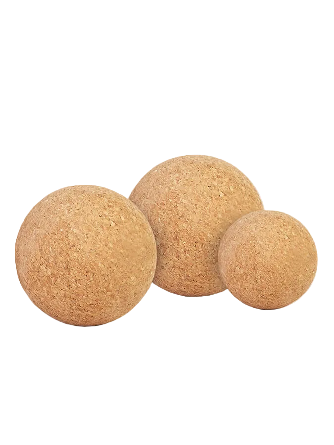 Three natural cork balls in different sizes on a plain white background.