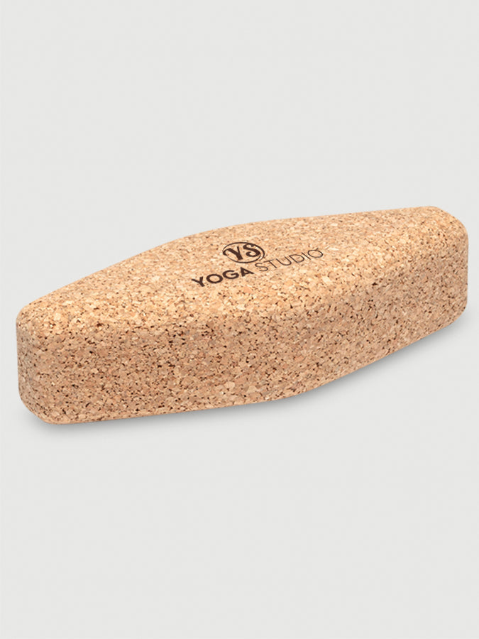 Cork yoga block with 'Yoga Studio' branding on a light gray background
