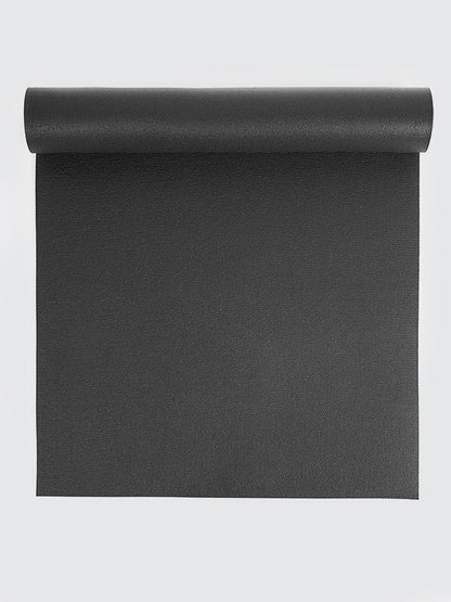 Black yoga mat rolled up on a light gray background