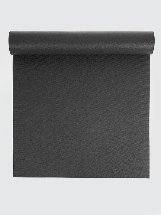 Black yoga mat rolled up on a light gray background