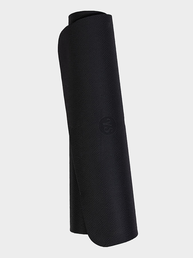 Rolled-up black yoga mat on a light gray background
