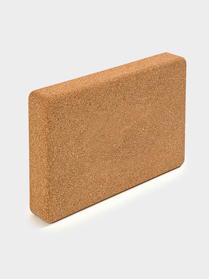 Cork yoga block on a white background