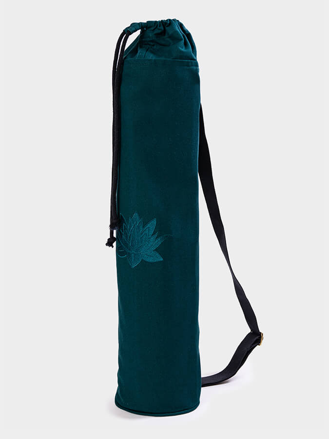 Teal yoga mat bag with a floral design on a white background