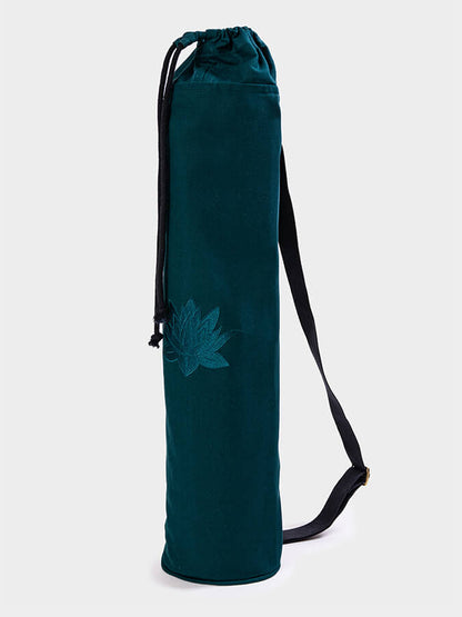 Teal yoga mat bag with a floral design on a white background
