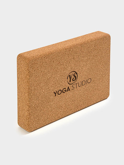 Cork yoga block with 'Yoga Studio' branding on a white background