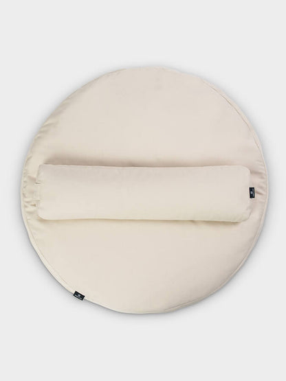Round beige cushion with a zipper on a light gray background